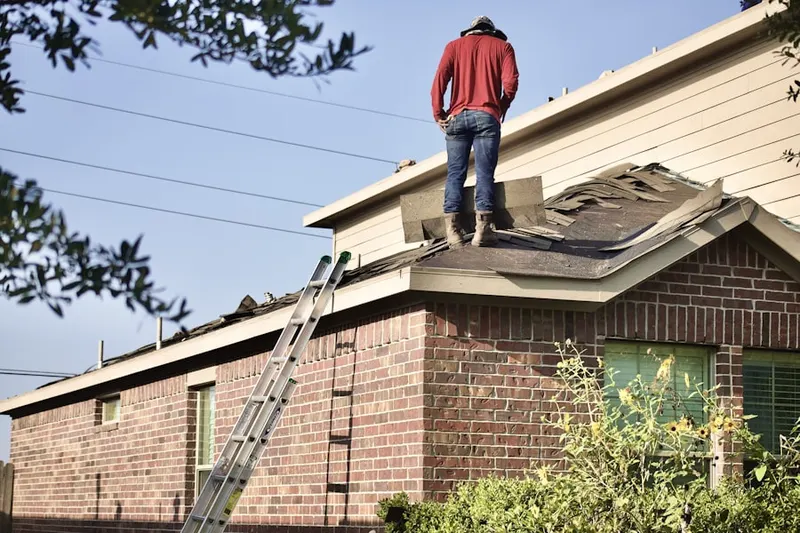 Professional roofer working on a residential roof in Belcaro